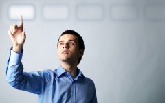 Image of young businessman pointing at virtual button