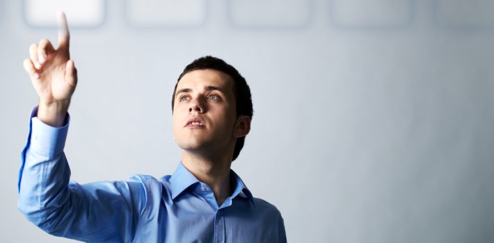 Image of young businessman pointing at virtual button